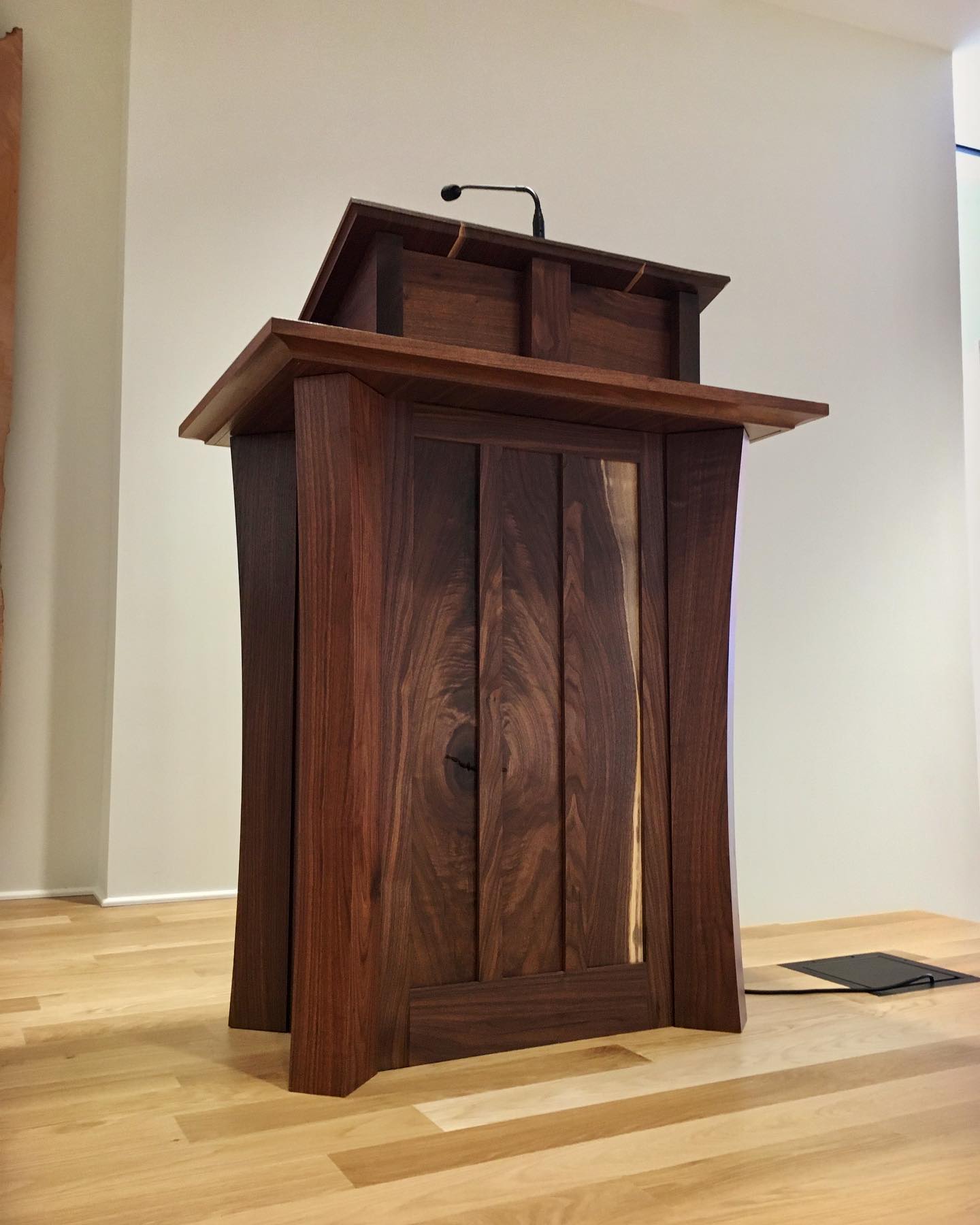 Custom walnut lectern with live-edge panel and gooseneck light