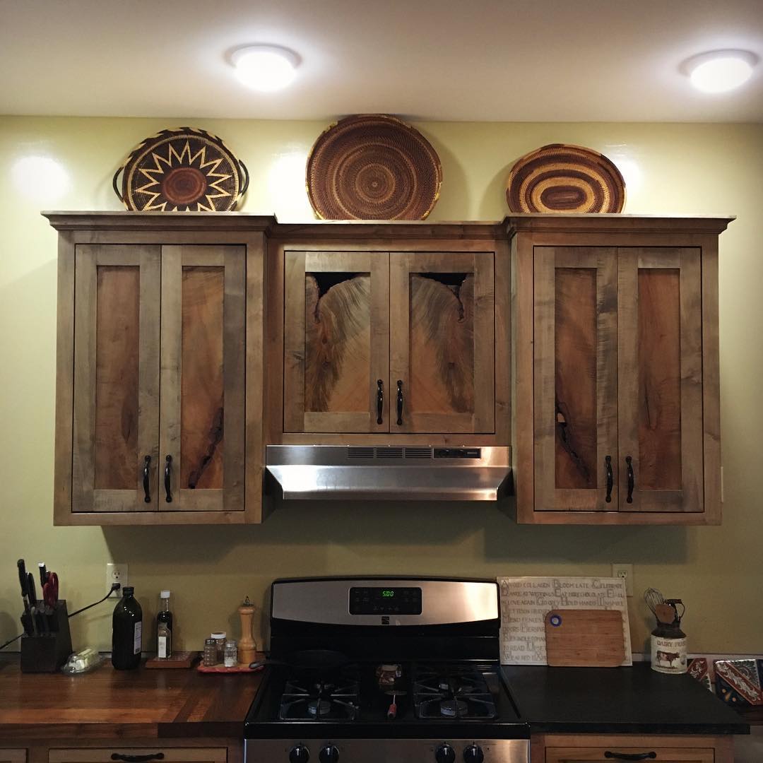 Custom kitchen cabinets with live-edge wood panel inserts